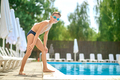 Boy standing at start near pool looking at camera - PhotoDune Item for Sale