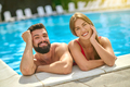 Man and woman smiling at camera in swimming pool - PhotoDune Item for Sale