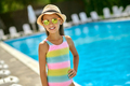 Girl in sunglasses smiling at camera near pool - PhotoDune Item for Sale
