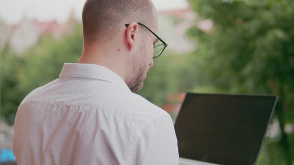 Freelancer Working on Laptop Outdoors