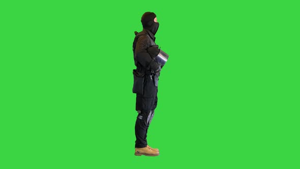 Riot Policeman Standing Holding His Helmet in Hands on a Green Screen Chroma Key