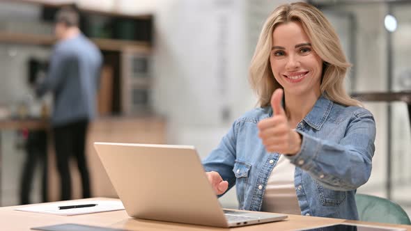 Positive Young Casual Woman with Laptop Showing Thumbs Up