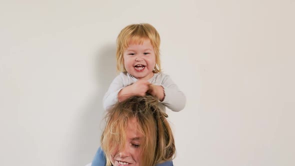Portrait of a happy mom and her daughter playing and having fun together.