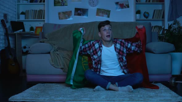 Young Man With Portuguese Flag Cheering National Team Home, Sports Competition