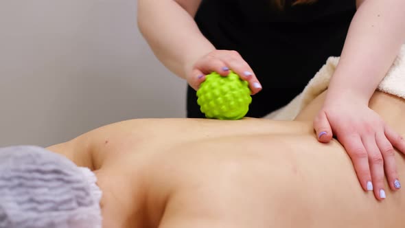 Woman at the Physiotherapy Receiving Ball Massage From Therapist