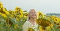 Happy smiling female kid standing in sunflowers field - PhotoDune Item for Sale