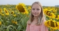 Happy smiling female kid standing in sunflowers field - PhotoDune Item for Sale