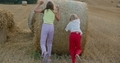 two girls have fun with straw stacks - PhotoDune Item for Sale