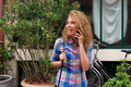 happy woman standing outside talking with mobile phone - PhotoDune Item for Sale