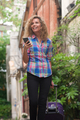 smiling woman with mobile phone and suitcase on street - PhotoDune Item for Sale