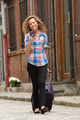 Full length woman walking with cellphone and suitcase on street - PhotoDune Item for Sale