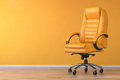 Yellow office chair in yellow interior with space for text. - PhotoDune Item for Sale