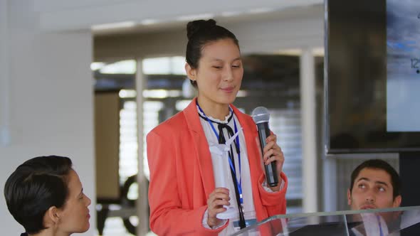 Female speaker addressing the audience at a business conference