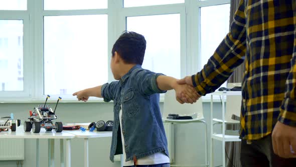 Boy Points His Hands on Toys