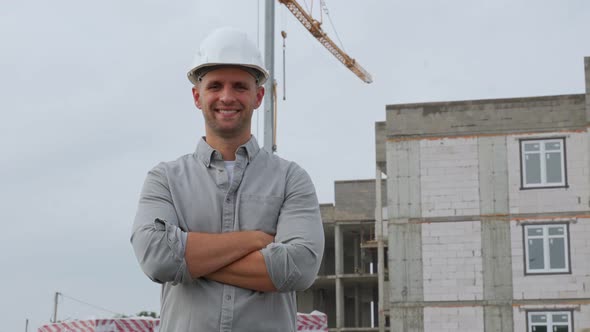 Portrait of a Beautiful Engineer with His Arms Crossed and Smiling at the Camera Against the