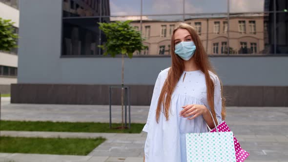 Teenager Girl with Multicolor Shopping Bags Wearing Protect Mask. Black Friday During Coronavirus