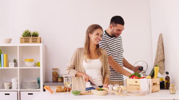 Happy Couple Cooking Food at Home Kitchen 