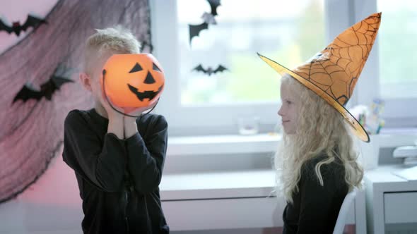 Halloween Kids Brother and Sister Preparing to Halloween Put on Costume at Home