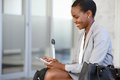 Smiling african businesswoman at airport using phone - PhotoDune Item for Sale