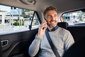 Happy mature man in taxi talking on phone - PhotoDune Item for Sale