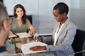 African businesswoman signing document during meeting - PhotoDune Item for Sale