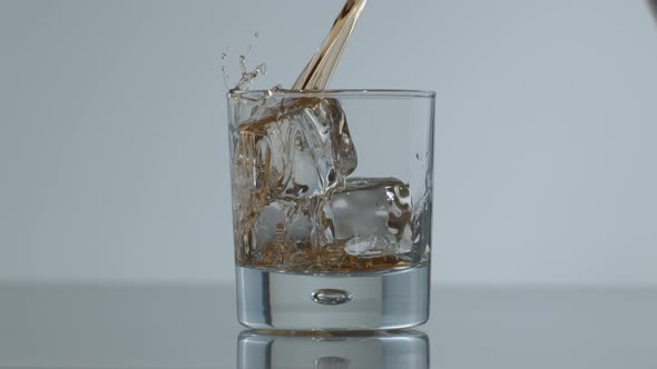 Whisky is poured over ice in slow motion; shot on Phantom Flex 4K at 1000 fps alt