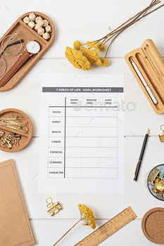 Desktop with goal setting template and office accessories
