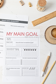 Desktop with goal setting template and office accessories