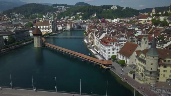 Chapel bridge at Lucerne and cityscape, Switzerland. Aerial forward