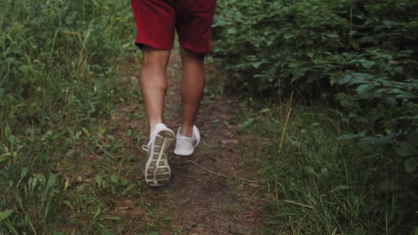 Close Up Hiking Man with Trekking Boots Walking in the Forest