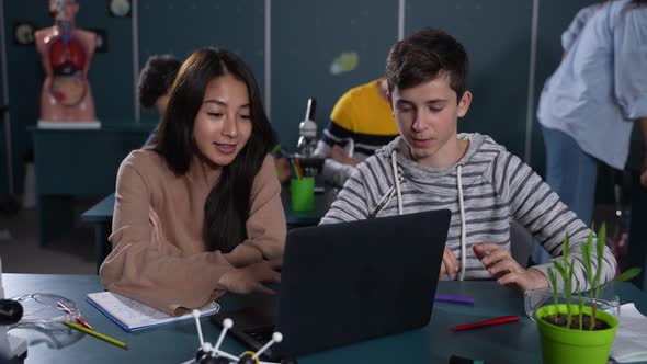 Friendly Multiracial Pupils Working During Lesson