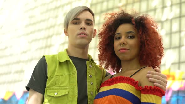 Couple of Pierced Teenagers in Colorful Clothes Looking Camera, Hanging Out