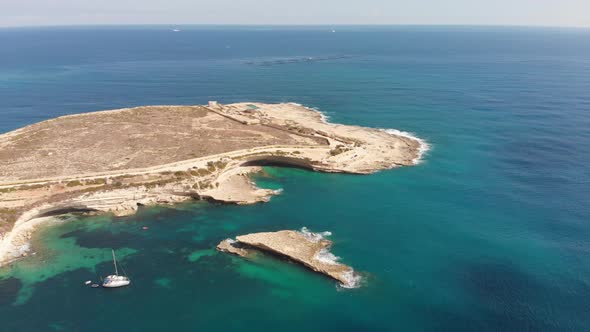 Aerial drone video from eastern Malta, Marsaxlokk area, Il-Hofra l-Kbira bay.