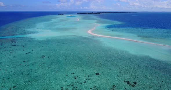 Wide aerial abstract view of a sandy white paradise beach and blue ocean background in colourful 4K