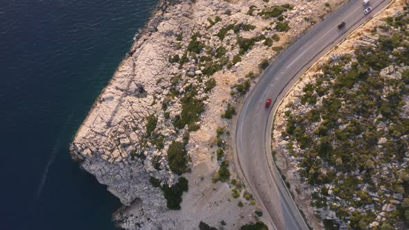 Aerial View of Cars Driving on the Road Along the Coastal Landscape