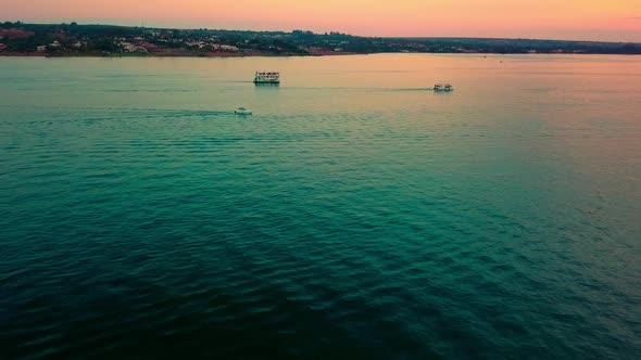 Slow aerial shot flying over Lake Paranoa at dusk