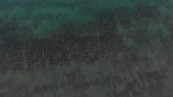 Aerial tilt-up view of Matadouro beach and Atlantic ocean