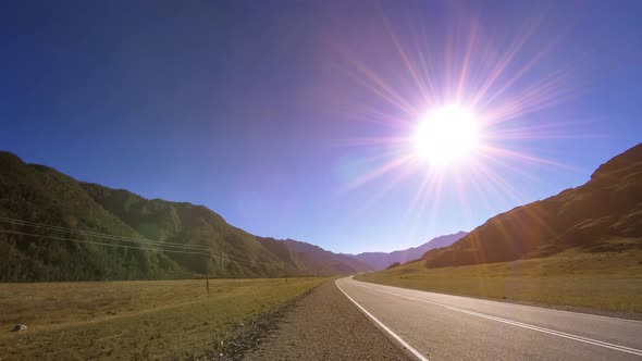 Mountain Road Timelapse at the Summer or Autumn Sunset Sunrise Time. Wild Nature and Rural Field.