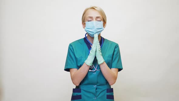 Medical Doctor Nurse Woman Wearing Protective Mask and Latex Gloves - Praying Nad Hoping Gesture