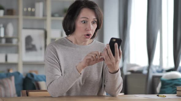 Old Woman in Shock While Using Smartphone