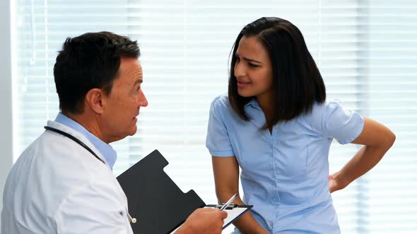 Patient suffering from stomach ache while consulting doctor