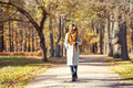 A young red-haired woman walks in an autumn park - PhotoDune Item for Sale