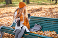 A girl drinks hot tea in the autumn square - PhotoDune Item for Sale