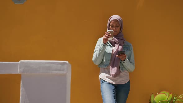 Young woman wearing hijab out and about in the city