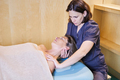 Osteopath giving a cervical massage to a mature woman - PhotoDune Item for Sale