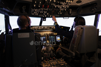 Woman copilot assisting captain to takeoff and fly airplane