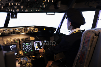 Copilot helping captain to fly airplane with cabin command