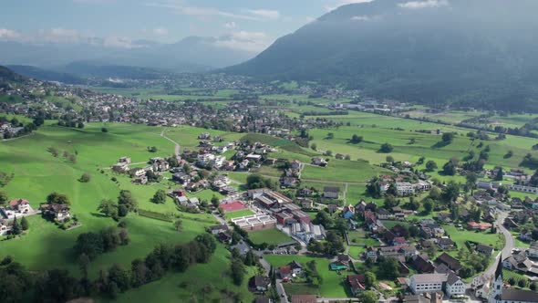 Aerial View of Liechtenstein with Houses on Green Fields in Alps Mountain Valley