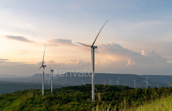 ergy. Wind turbines generate electricity. Windmill farm on mountain with sunset sky. Green technology. Renewable resource. Sustainable development.