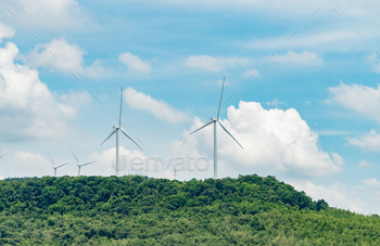ergy. Wind turbines generate electricity. Windmill farm on a mountain with blue sky. Green technology. Renewable resource. Sustainable development.